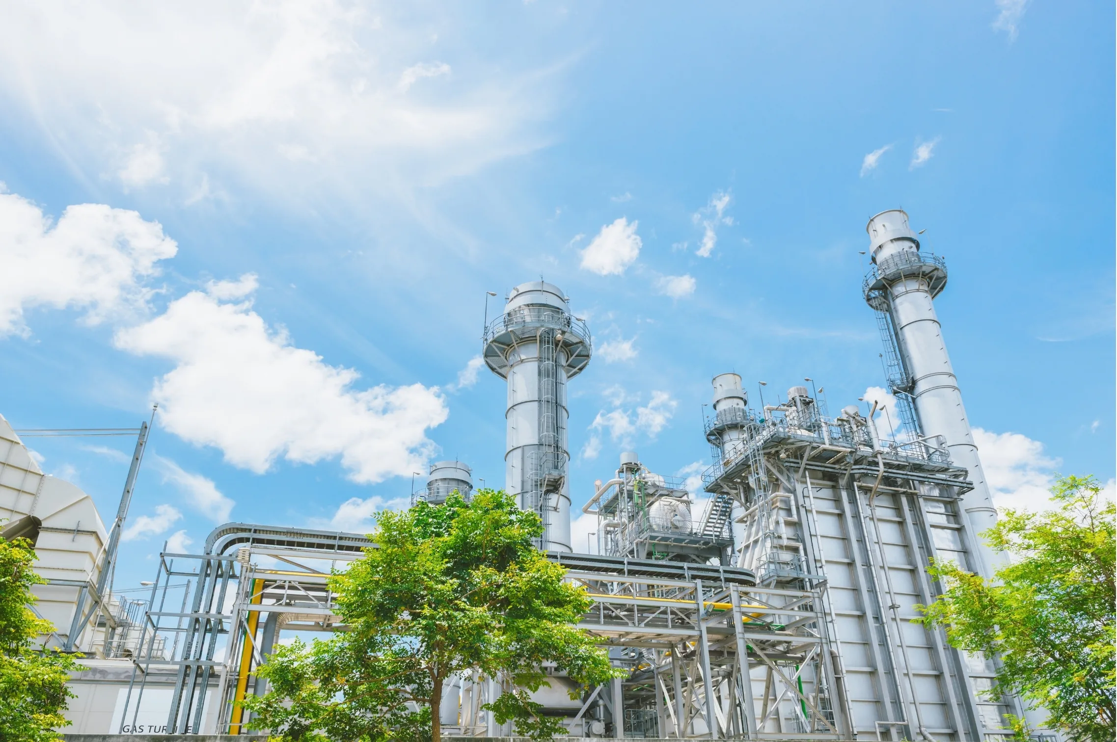 Combined-cycle power plant under a clear blue sky